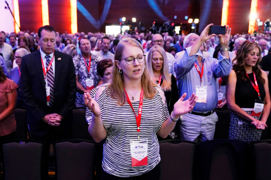 Audience members pray at the start of the Family Leadership Summit in Des Moines, Iowa, on July 14, 2023.