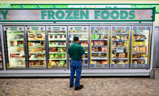 A man looks at frozen foods for sale at a Dollar Store in Alhambra, Calif. on Aug. 23, 2022.