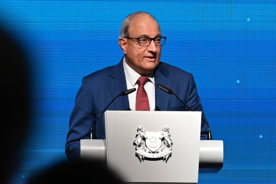 S. Iswaran speaks on stage at a podium