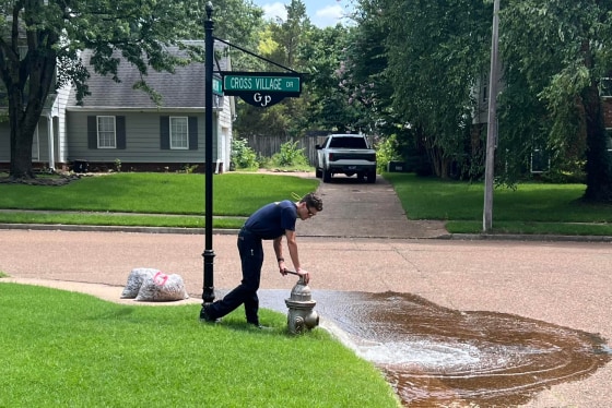 A firefighter flushes a hydrant in Germantown, Tenn.