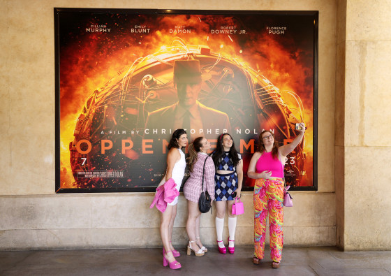 Image: Gabrielle Roitman, Kayla Seffing, Maddy Hiller and Casey Myer take a selfie in front of an "Oppenheimer" movie poster before they attended an advance screening of "Barbie" on Thursday in Los Angeles.