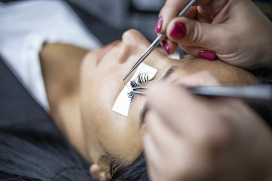 Female eye with long lashes. Eyelash extension procedure. Eyelashes, close-up, macro, selective focus