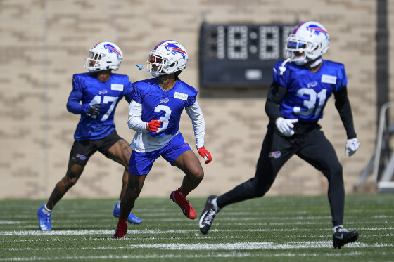 Buffalo Bills safety Damar Hamlin, center, runs a drill with cornerback Christian Benford, left, and safety Dean Marlowe during practice at the NFL football team's training camp in Pittsford, N.Y., Sunday, July 30, 2023.