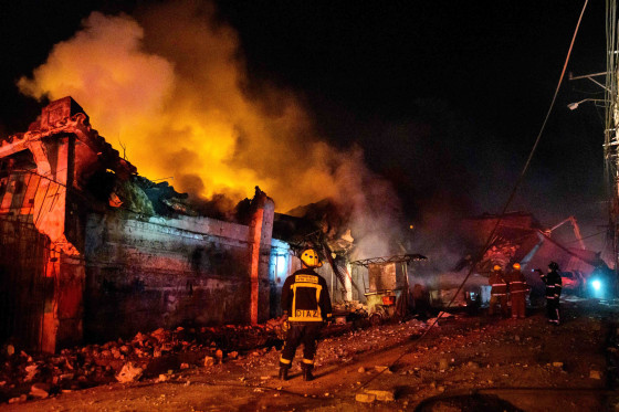 Firefighters work to extinguish a fire after an explosion in San Cristobal, Dominican Republic