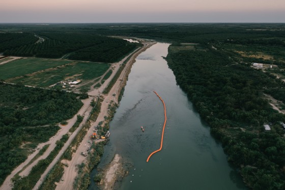 Floating orange buoy barrier on the Rio Grande river.