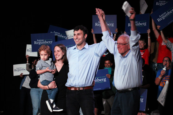 Former state Rep. Aaron Regunberg, center, cheers during a rally alongside his family and Sen. Bernie Sanders