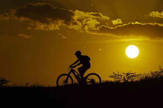 A person rides their bike in San Antonio during a heat wave