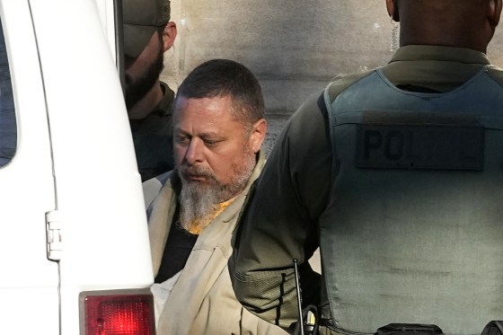 Officers escort Richard Matthew Allen out of the Carroll County courthouse following a hearing, Nov. 22, 2022, in Delphi, Ind.