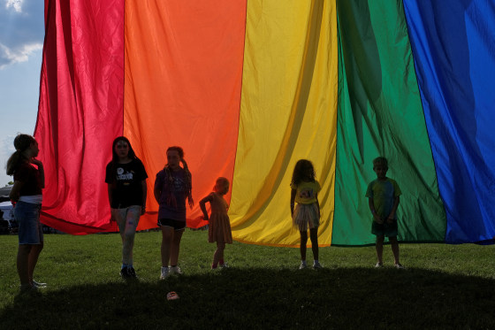 Children hold the rainbow flag during an LGBTQ Pride event in Franklin, Tenn., on June 3, 2023. 