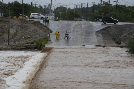 Residents watch a canal flooded during Hurricane Norma in La Paz, Mexico, on Sunday.