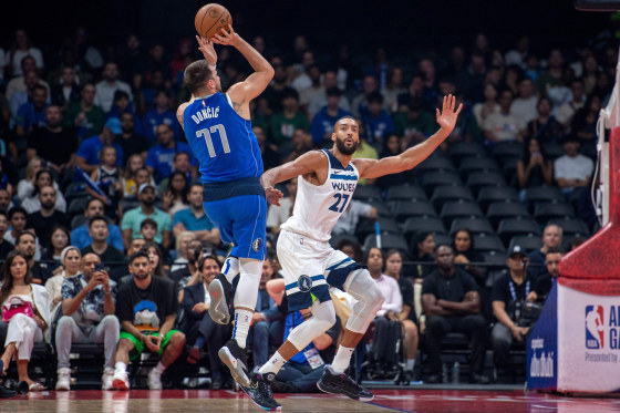 Dallas Mavericks' guard Luka Doncic pulls up for a shot as he is guarded by Minnesota Timberwolves' center Rudy Gobert during an NBA preseason game in Abu Dhabi on Oct. 5, 2023.