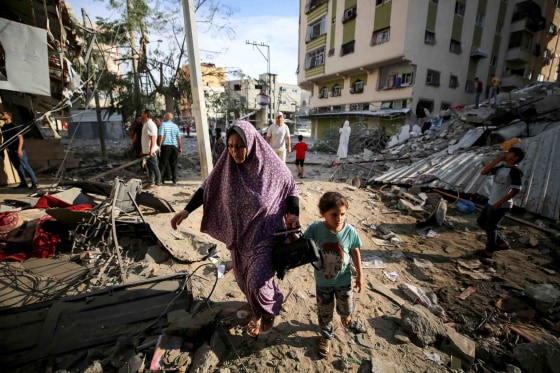 Image: Palestinians on a damaged Gaza City street