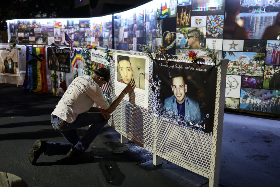 William True spends a moment in front of a picture of his friend Luis Omar Ocasio-Capo at the memorial for 49 victims of the Pulse nightclub shooting in Orlando, Fla. on June 11, 2018.