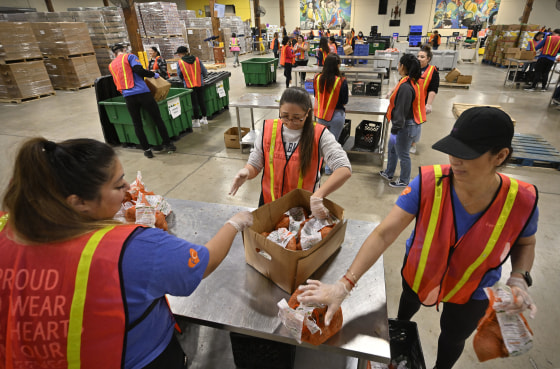 Volunteers process potatoes inside Second Harvest Food Bank
