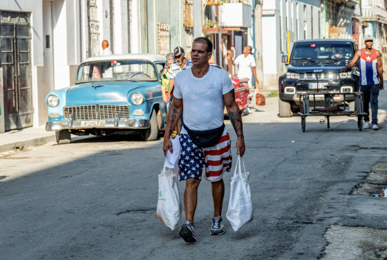 A man wearing shorts with the U.S. flag walks along a street in Havana, Cuba on Oct. 31, 2023.