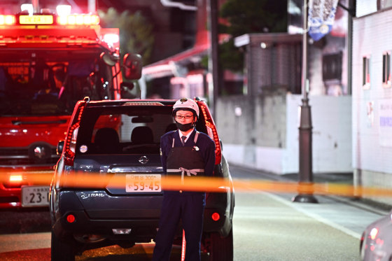 A suspected gunman has taken at least two people hostage in a post office in Japan after wounding two other people in a shooting at a hospital.