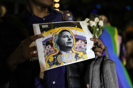 A demonstrator holds a picture of Aguascalientes state electoral court magistrate Jesus Ociel Baena in Mexico City on Nov. 13.