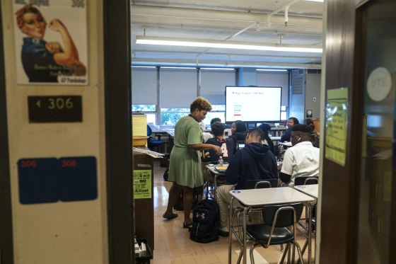 A teacher talks to a student during an African American Studies AP class