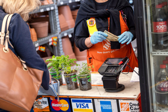 A cashier rings up a customer at Home Depot