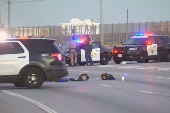 Emergency personnel work at the scene of a fatal shooting on a closed interstate.