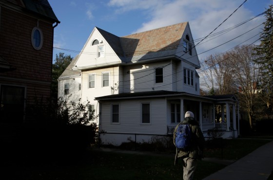 A student walks by the apartment house where Jason Eaton was staying.