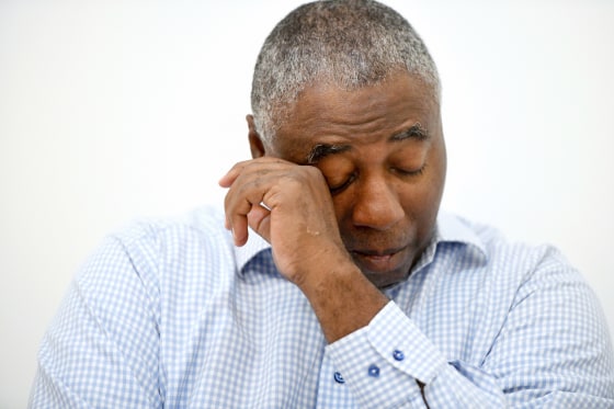 Charles Richardson wipes his eye while discussing his alleged abuse decades ago by a Catholic priest.