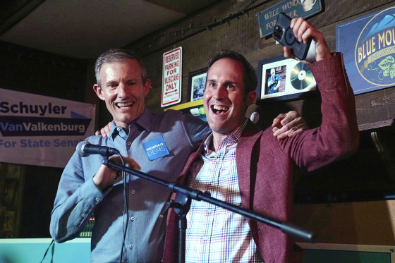 Democrats Del. Rodney Willett and Del. Schuyler VanValkenburg cheer at a party