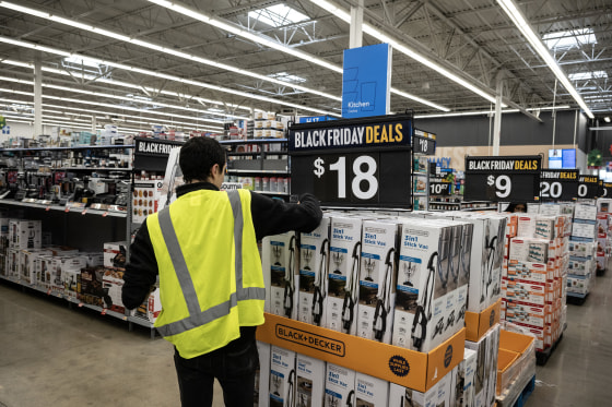 A worker stocks vacuums at a Walmart store on Black Friday in Secaucus, N.J., on Nov. 24, 2023.