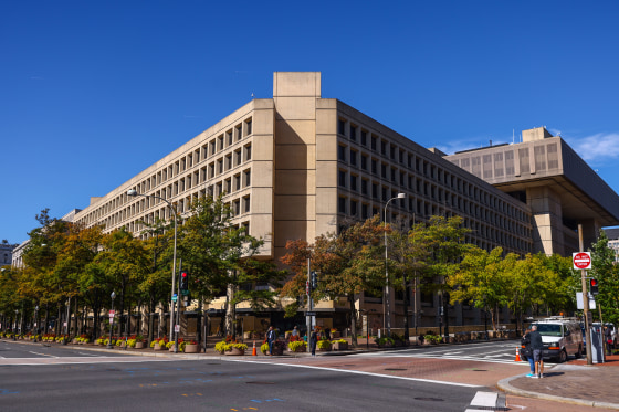 People walk in front of the FBI's headquarters.