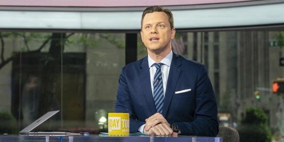 Willie Geist sitting at the desk with a yellow Sunday TODAY mug