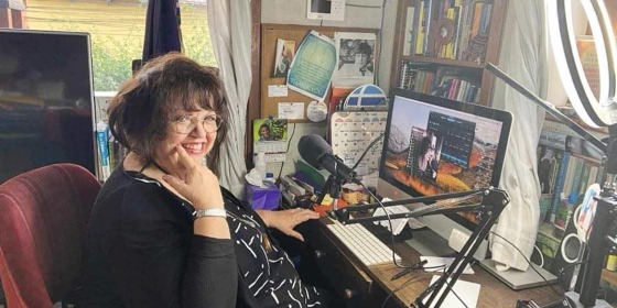 Maria Martin at her desk with her radio production equipment at her home in Guatemala. 