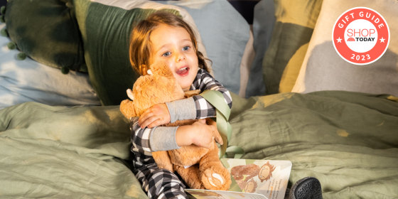 little girl hugging a teddy bear