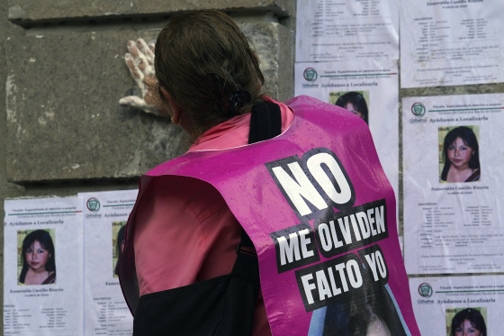 A woman wears a sign that says, "Do not forget me, I am missing" as human rights activists and other relatives of missing persons protest in front of the Secretary of the Interior building in Mexico City on May 29, 2023. 