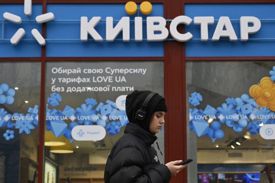 A woman walks by a Kyivstar store in Kyiv, Ukraine