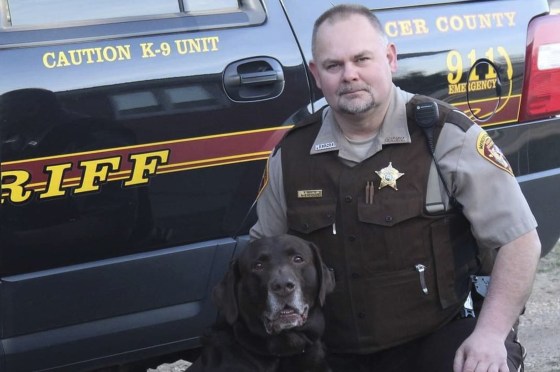 Sheriff's Deputy Paul Martin with his retired K9 Goliath.