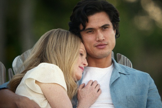 Julianne Moore puts her head on Charles Melton's shoulder.
