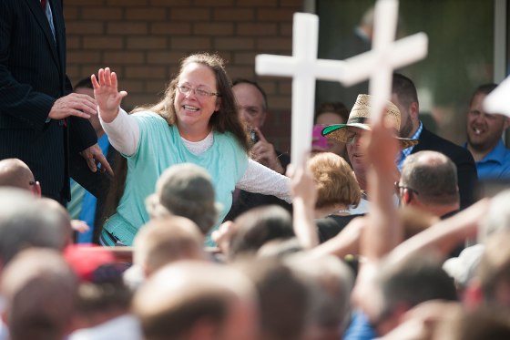 Rowan County Clerk of Courts Kim Davis waves to a crowd of her supporters at a rally in front of the Carter County Detention Center on Sept. 8, 2015 in Grayson, Ky.