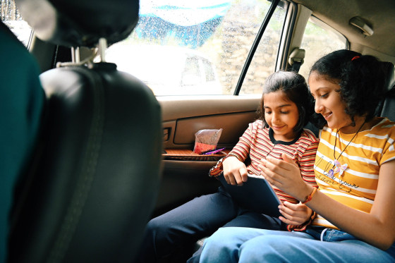 Two Girls playing/ watching on digital tablet