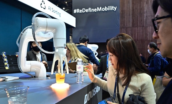 The Mix Master Moodie, an AI-generated cocktail maker from Doosan Robotics, delivers a drink during a display at the Consumer Electronics Show on Jan. 9, 2024 in Las Vegas.