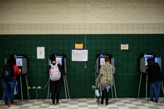 Voters fill out ballots.