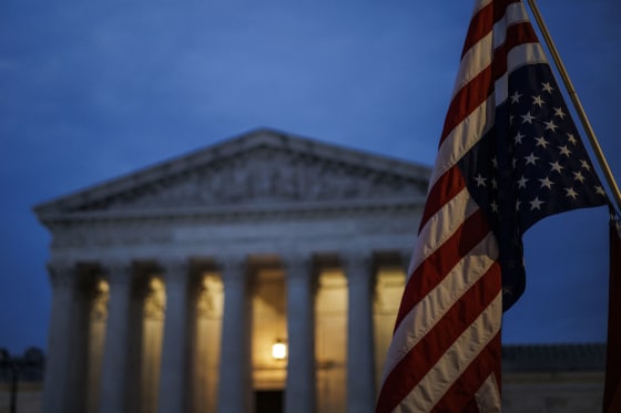 An abortion rights activist flies an upside down US flag, the international sign of distress, outside of the Supreme Court during a protest in Washington, D.C., on June 26, 2022, two days after the court scrapped half-century constitutional protections for the procedure.