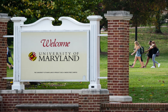 Pedestrians walk across the Chapel Lawn at The University of Maryland