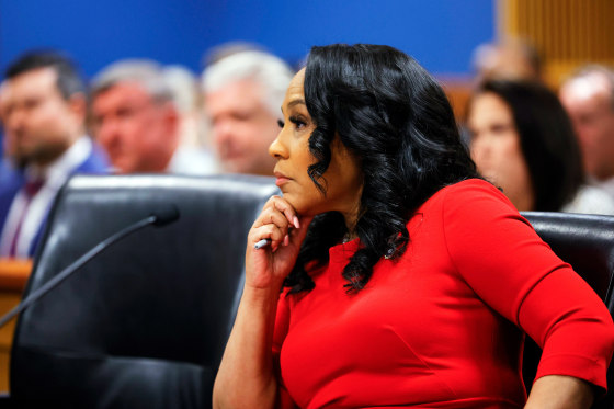 Fani Willis listens during a hearing