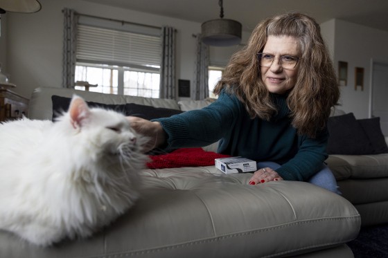 Donna Cooper pets her cat Cade at her home in Front Royal, Va., on Friday, March 1, 2024. Cooper has heard that people gain back weight when they stop using drugs like Wegovy, but she hopes to be an exception.