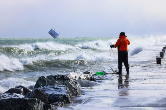Rae-Ann Eifert gathers buckets of water for testing from Lake Michigan
