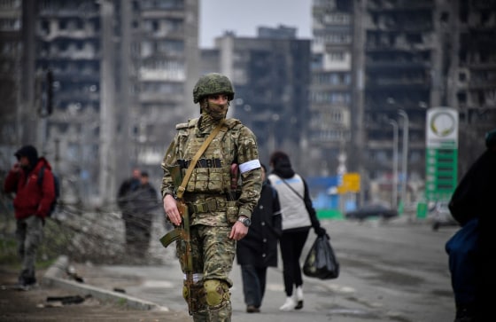 A Russian soldier patrols in a street of Mariupol