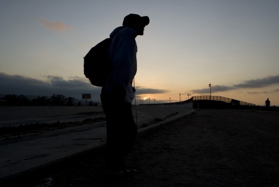 A man planning to cross into the U.S. illegally stands near the Tijuana River basin, on the Mexican side of the U.S.-Mexico border, in Tijuana, Mexico