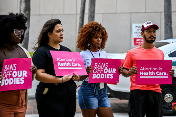 Members of Florida Planned Parenthood PAC Abortion rights activists hold signs that read "Bans off our Bodies, " and "Abortion is Health Care"