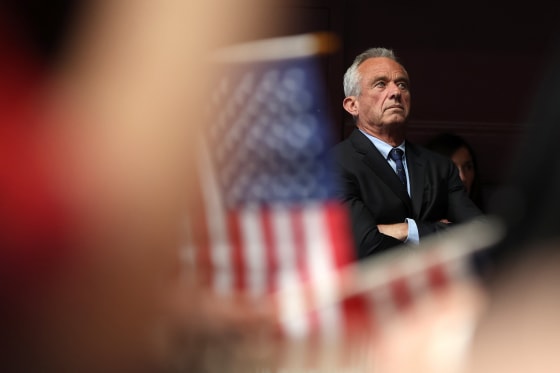 Robert F. Kennedy Jr. stands with his arms crossed