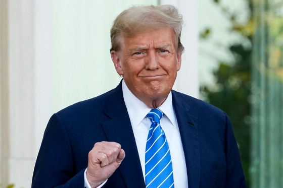 Donald Trump pumps his fist as he arrives for a GOP fundraiser